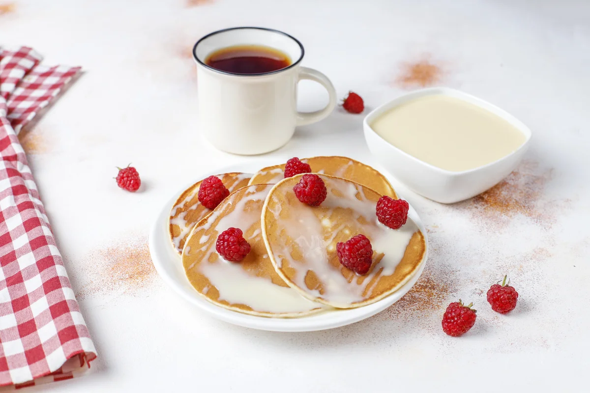 Fluffy almond milk pancakes stacked on a plate.