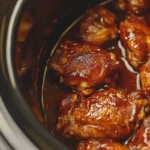 Juicy crockpot barbecue chicken thighs ready to serve.