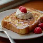 Golden sourdough French toast topped with syrup.